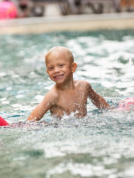 Young child playing in the caribbean resort pool